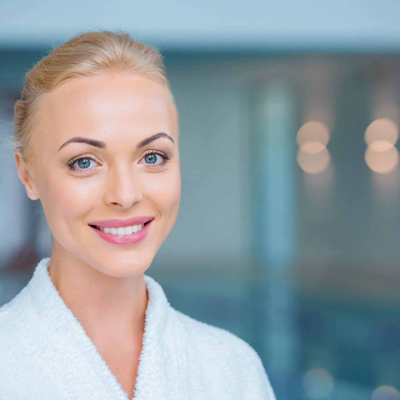 Blonde woman smiling at luxury med spa in Bentonville, Arkansas